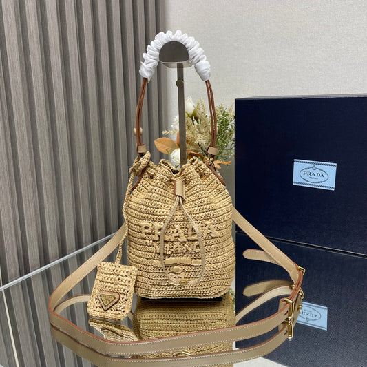 PRADA BUCKET BAG 20 IN BEIGE WOVEN RAFFIA EMBOSSED LOGO