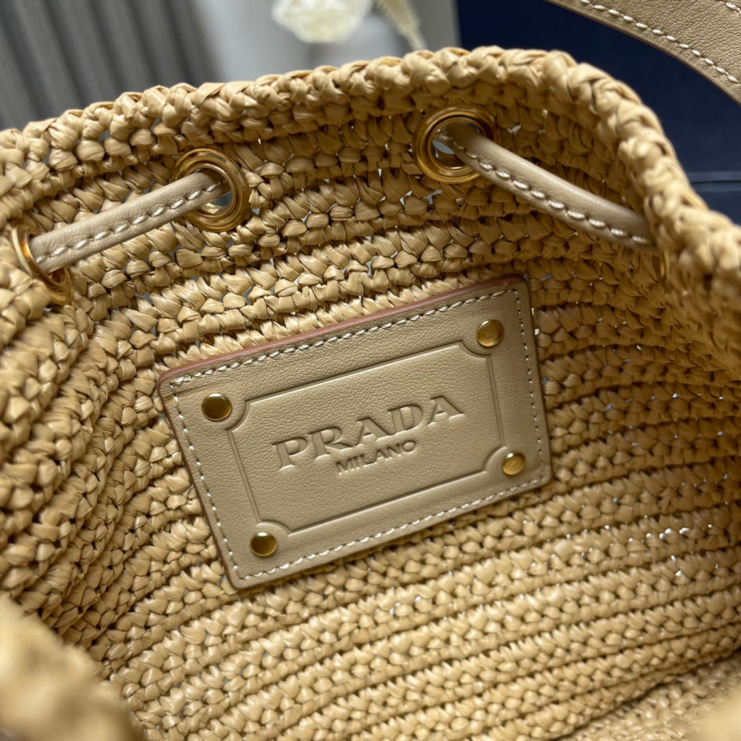 PRADA BUCKET BAG 20 IN BEIGE WOVEN RAFFIA EMBOSSED LOGO